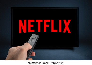 USA, NEW YORK February 2, 2021: Close up of Nvidia Sheild TV Remote in Hand and TV Screen with Netflix Logo, Netflix is a well known global provider of streaming movies and TV series
