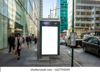 USA, New York May 6, 2019. Vertical Blank White Billboard Mockup For Advertising, Bus Stop At City Buildings And Street Background