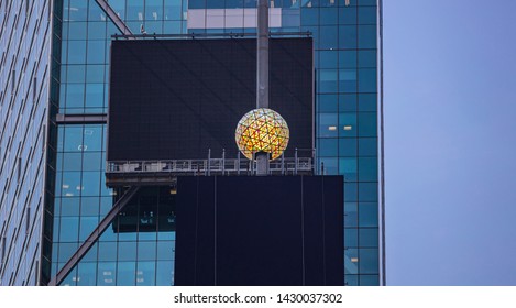 USA, New York, Times Square. May 2, 2019. Colorful Crystal New Years Eve Ball And Black Blank Billboards On Glass Skysraper Facade Background.