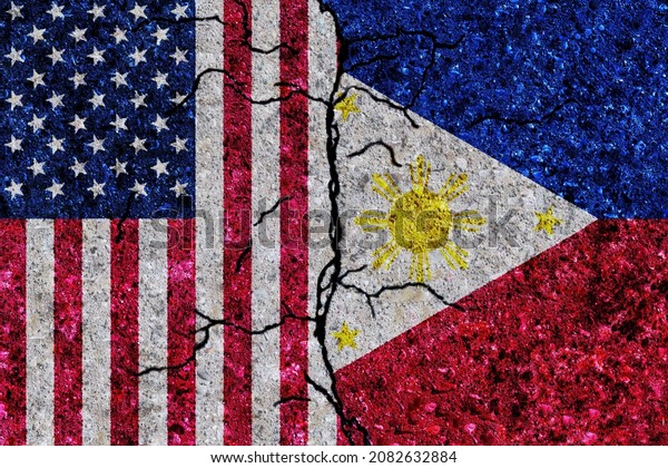 USA and Philippines\
painted flags on a wall with grunge texture. USA and Philippines\
conflict. United States of America and Philippines flags together.\
USA vs Philippines