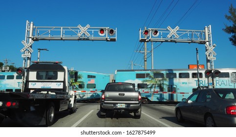 USA, Pompano Beach - May 8, 2017 - Tri Rail, Passengers Train At A Car Rail Road Crossing In South Florida