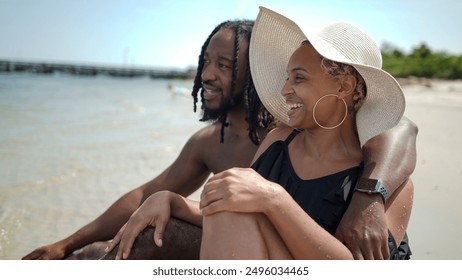 USA, Smiling couple sitting on beach - Powered by Shutterstock