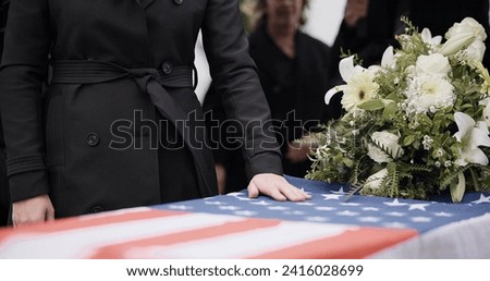 USA veteran funeral, woman and casket with touch, sad family and flag for mourning, depression and respect. Widow, people and army service with coffin, burial or memorial for war hero in Philadelphia