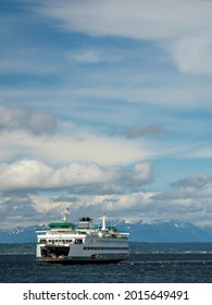 Usa, Washington State, Seattle, ferry in Puget Sound with Olympic Mountains in the distance.