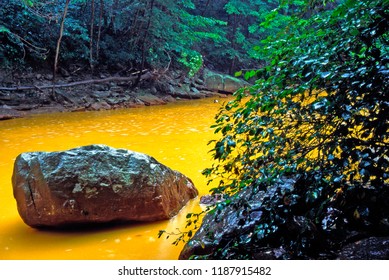 USA, West Virginia, Preston County, Acid Mine Run-off Has Stream Running Orange