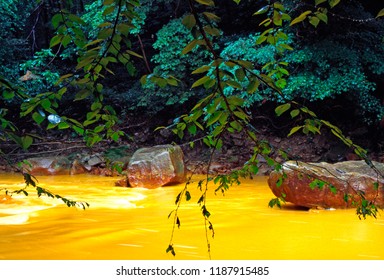 USA, West Virginia, Preston County, Acid Mine Run-off Has Stream Running Orange