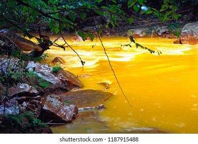 USA, West Virginia, Preston County, Acid Mine Run-off Has Stream Running Orange