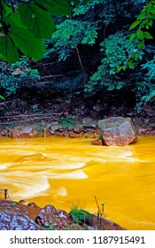 USA, West Virginia, Preston County, Acid Mine Run-off Has Stream Running Orange