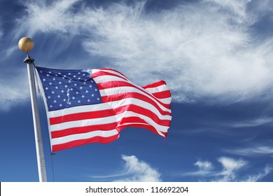 USA. Windblown flag of the United States of America over sky background.