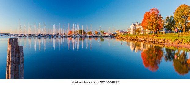 USA, Wisconsin. Panoramic View Of Fall Colors Reflected On The Still Waters Of The Harbor In Bayfield On Lake Superior.