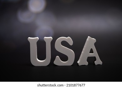 USA, word dark background with bokeh. Signs and Symbols.