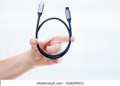USB 3.1 type C cable in the hands of the girl