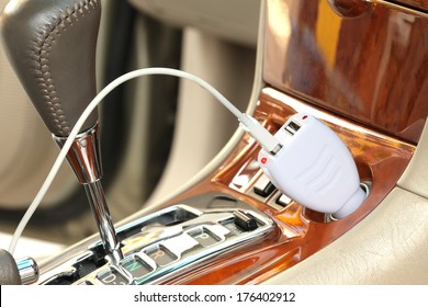 USB Adapter Converter Plug With Charging Cable On A Car