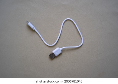 the usb cable lying on the brown table
