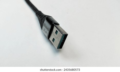 USB cable on a white background, close-up, selective focus - Powered by Shutterstock