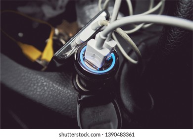 A Usb Car 12 Volt Usb Cigarette Lighter Charging Port In The Interior Of A Messy Car. Charging Phone And Digital Electronic Equipment On The Move With Alternator. 12 Volt Convertor Usb Socket