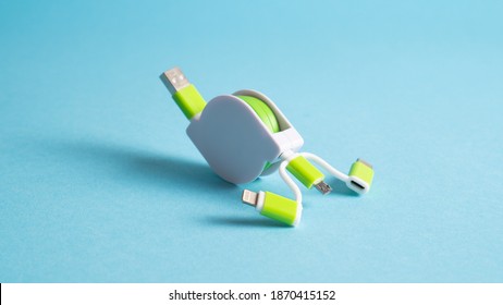 USB Charger Cable Adapter For Mobile. Universal Mobile Charger Isolated On Blue Background. Cellphone Usb Charging Plugs