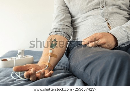 USB charging cable connected to hand like a drip. battery charging symbol.  Tiredness, recharging, vitality, pressure, overwork, stamina, fatigue,  burnout. Life energy concept.