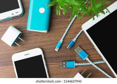 USB charging cables for smartphone and tablet in top view - Shutterstock ID 1144637945