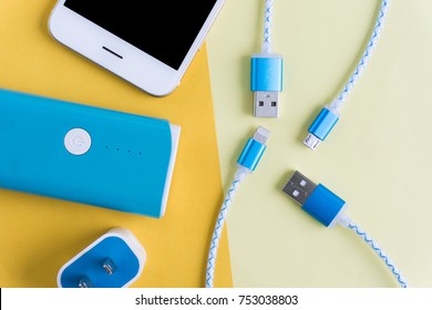 USB charging cables for smartphone and tablet in top view on yellow background