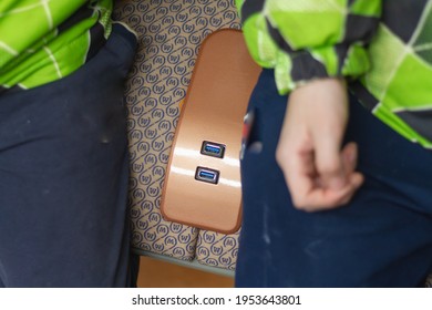 USB charging for gadgets in a modern subway car on a passenger seat in Moscow in Russia