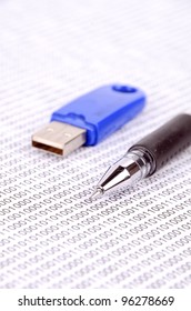 USB flash disk and pen on binary code