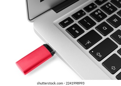 Usb flash drive attached into laptop on white background