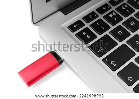 Usb flash drive attached into laptop on white background