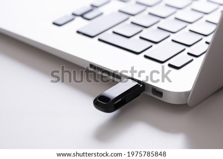 USB flash drive connected to the laptop's usb socket. Pendrive, flash memory concept
