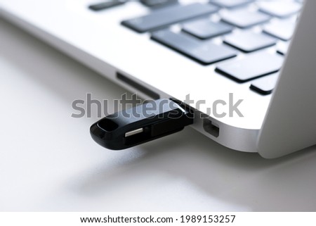 USB flash drive connected to the laptop's usb socket. Pendrive, flash memory concept