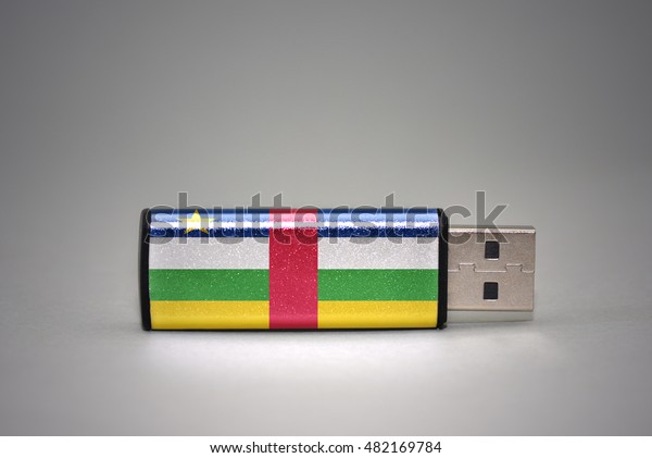 usb flash drive with the
national flag of central african republic on gray background.
concept