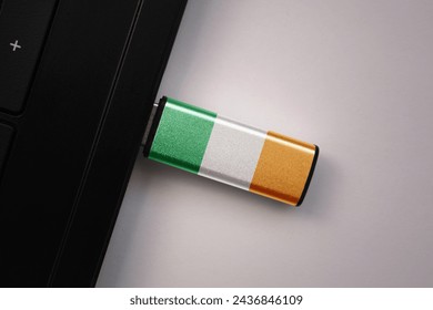 usb flash drive in notebook computer with the national flag of ireland on gray background. concept