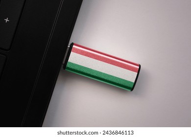 usb flash drive in notebook computer with the national flag of hungary on gray background. concept