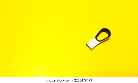 USB flash memory or USB stick isolated on yellow background. USB flashdisk.