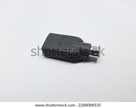 a USB to PS2 connector converter on a white background