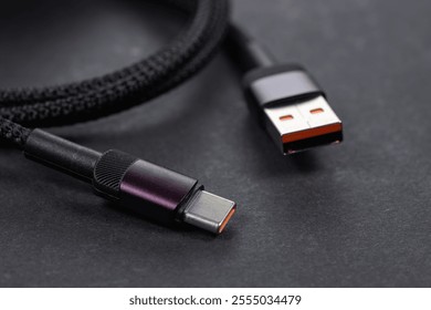 USB type A, USB type C cable on dark background.