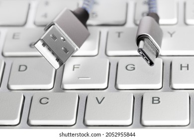 USB type C charging cables for data transfer connectors peripheral cable on keyboard. Close up