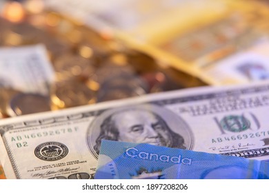 USD, United States Dollar And Canadian Dollar Bill In Front. Euro In The Background