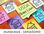 USDA home loan and drawn homes on a paper.