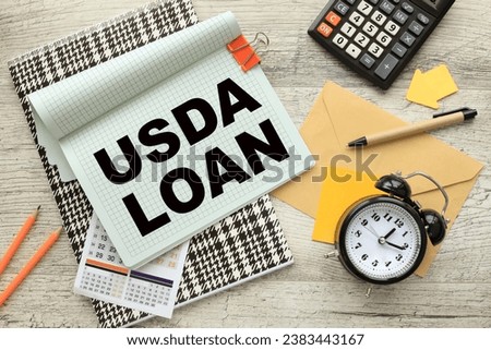 USDA LOAN open notepad on colorful notepad. calculator. a table clock