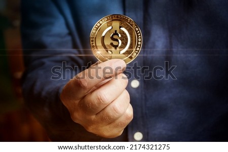 USDC USD Coin stablecoin cryptocurrency golden coin in hand abstract concept
