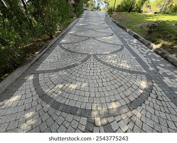 Use of cube stone in landscape application, perspective stone pavements. Square with a large dark gray circle inside a small round of cobblestone cubes. Stone background.  - Powered by Shutterstock