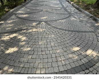 Use of cube stone in landscape application, perspective stone pavements. Square with a large dark gray circle inside a small round of cobblestone cubes. Stone background.  - Powered by Shutterstock