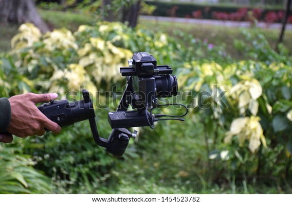 Use a gimbal camera\
stabilizer to take recordings outdoors with modern mirrorles\
professional cameras