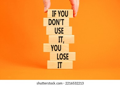 Use Or Lose Symbol. Concept Words If You Do Not Use It You Lose It On Wooden Blocks On A Beautiful Orange Background. Businessman Hand. Business Motivational And Use Or Lose Concept.