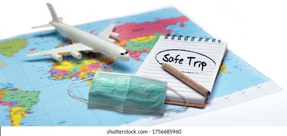 Use Mask And Safe Flight Check List On Note Book To Go Aboard Travel With Plane After Coronavirus Pandemic Recrase Lock Down.