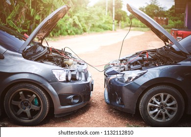 Use New Car Battery To Start The Engine Of The Vehicle Using Cables,Trying To Jump Start A Car's.safely Jump Start A Dead Battery Concept.