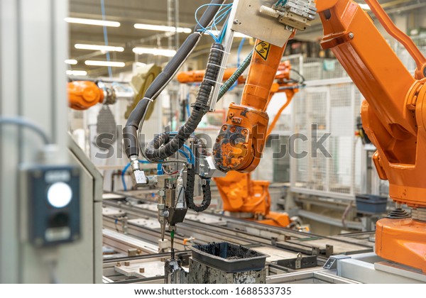 use of robotic arms in the production of cars in\
the automotive industry