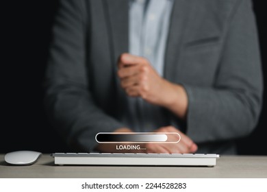 Use your computer to download the program and wait for it to load. loading bar symbol Businessman downloading digital business data form website and cloud to laptop.