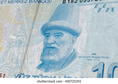 A Used 100 Turkish Lira Banknote Showing The Composer Buhurizade Mustafa Itri.  Banknote Photographed At An Angle.